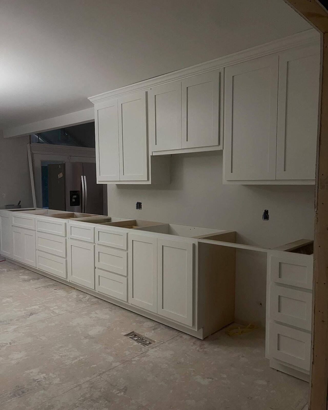 New white shaker kitchen cabinets installed and ready for countertops