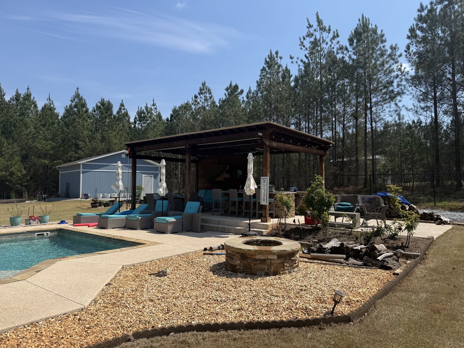 Covered poolside pavilion with an outdoor bar and seating in Harris County, GA