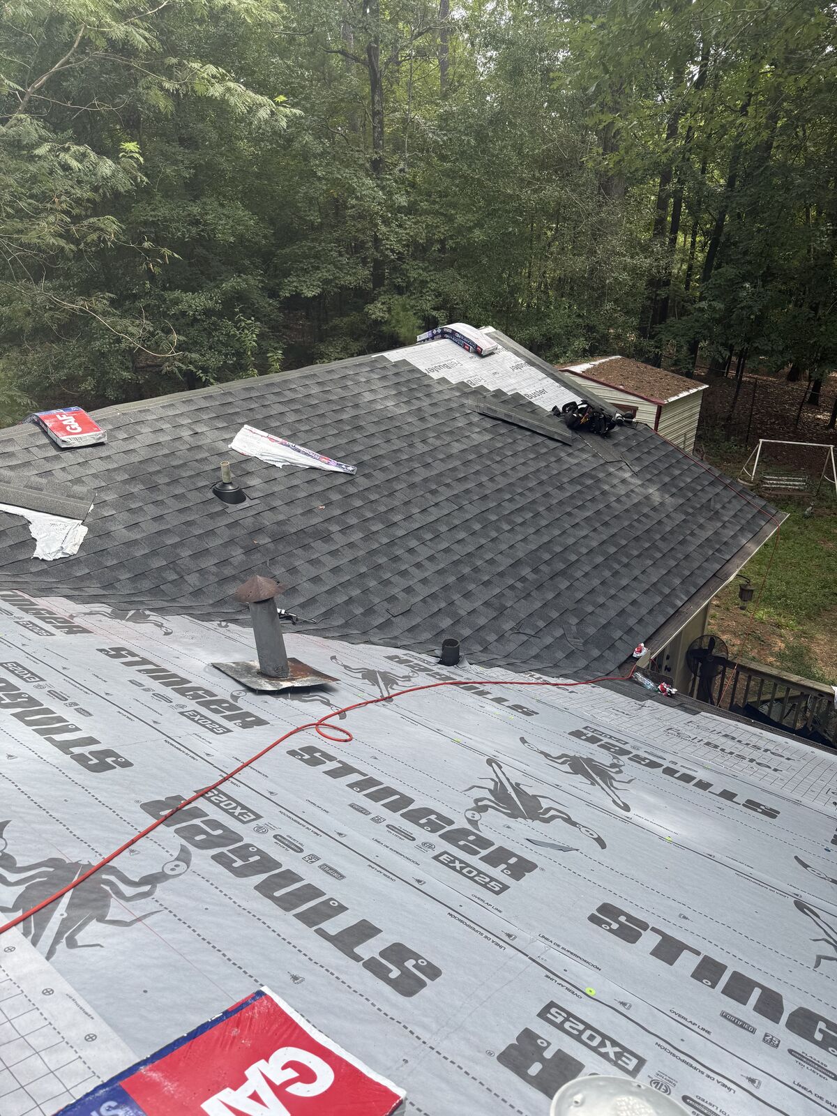 Roof replacement in Columbus, GA: architectural shingles going on over synthetic underlayment